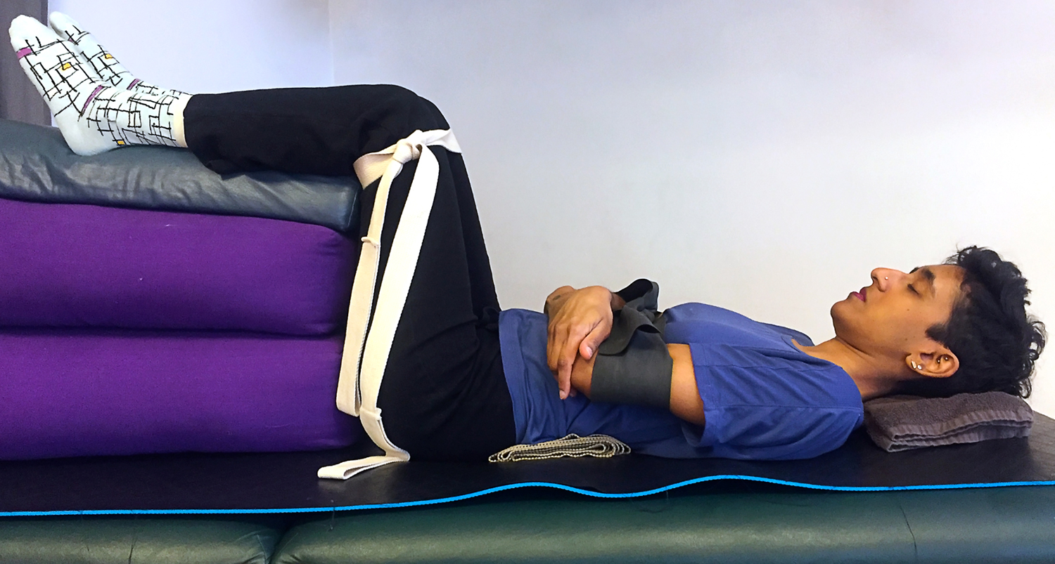 Vy lying in constructive rest at a Pilates studio.