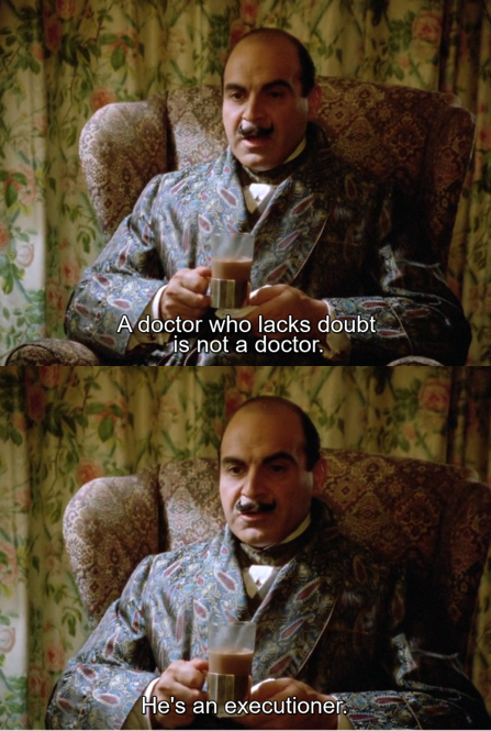 Poirot wearing a paisley dressing gown and drinking a tisane.