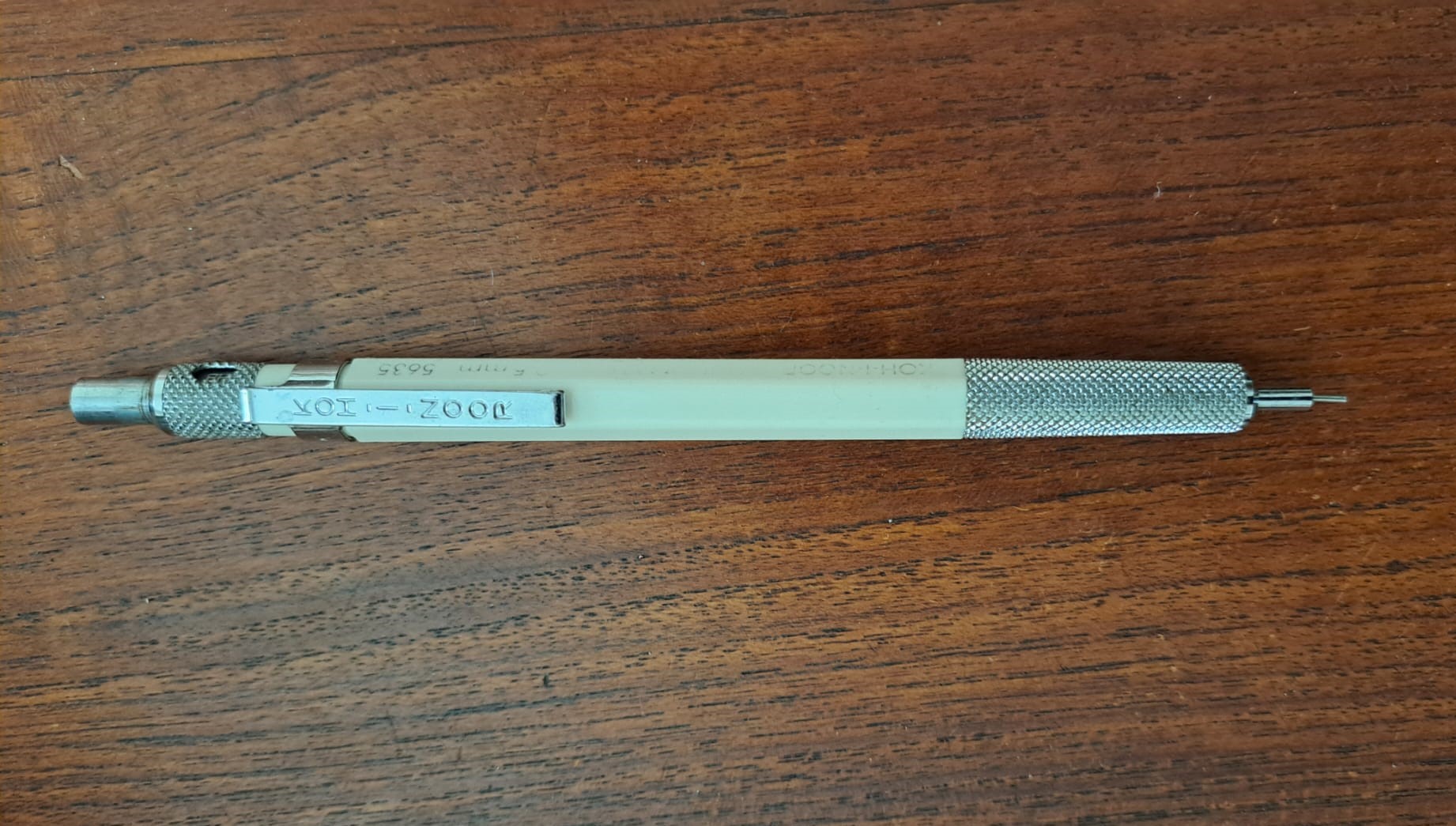 An original Koh-i-Noor Rapidomatic, a balanced, tip-weighted drafting pencil with an off-white body, knurled metal grip and lead sleeve, metal clip, and rotating hardness indicator ring.